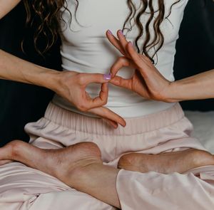 Close-up on hands in a specific yoga mudra.